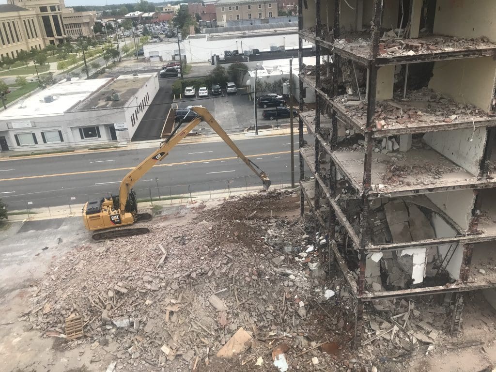 Partly demolished building with a pile of rubble