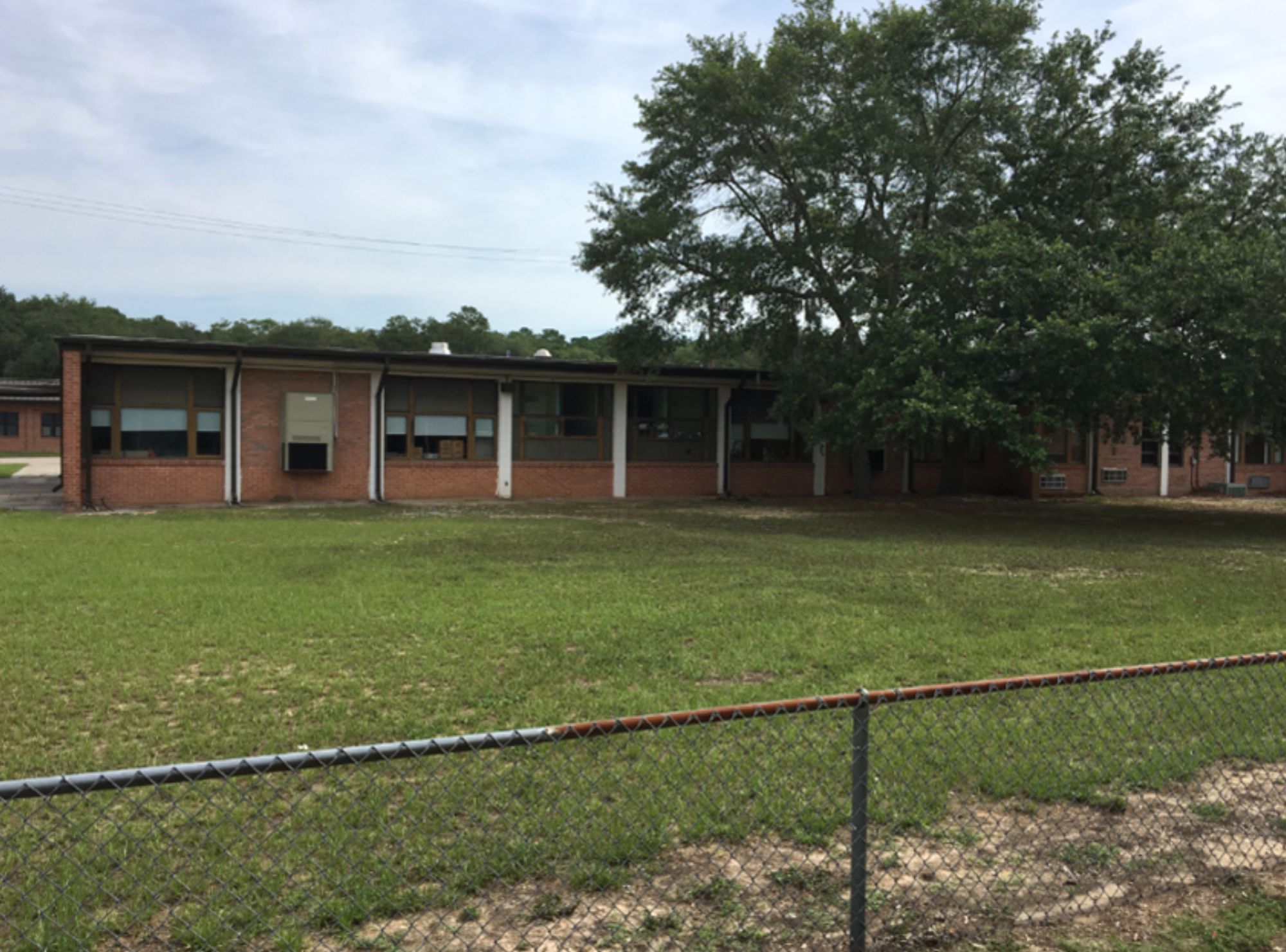 Low brick building with a lawn in front