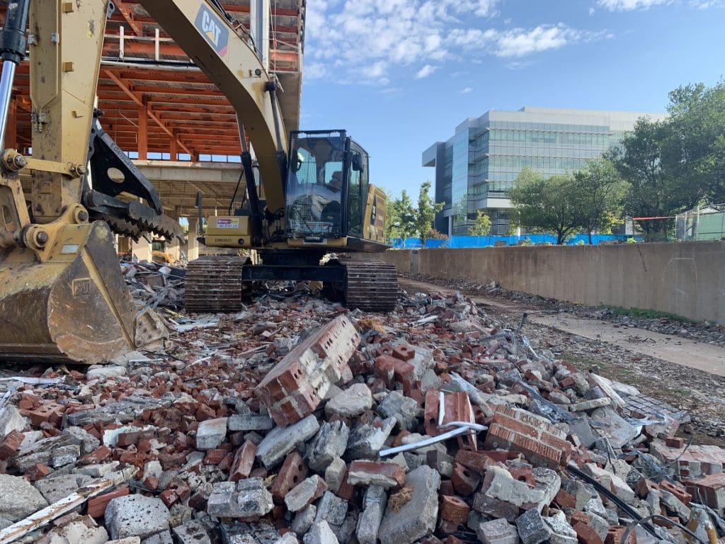 Excavator working in crushed concrete and brick