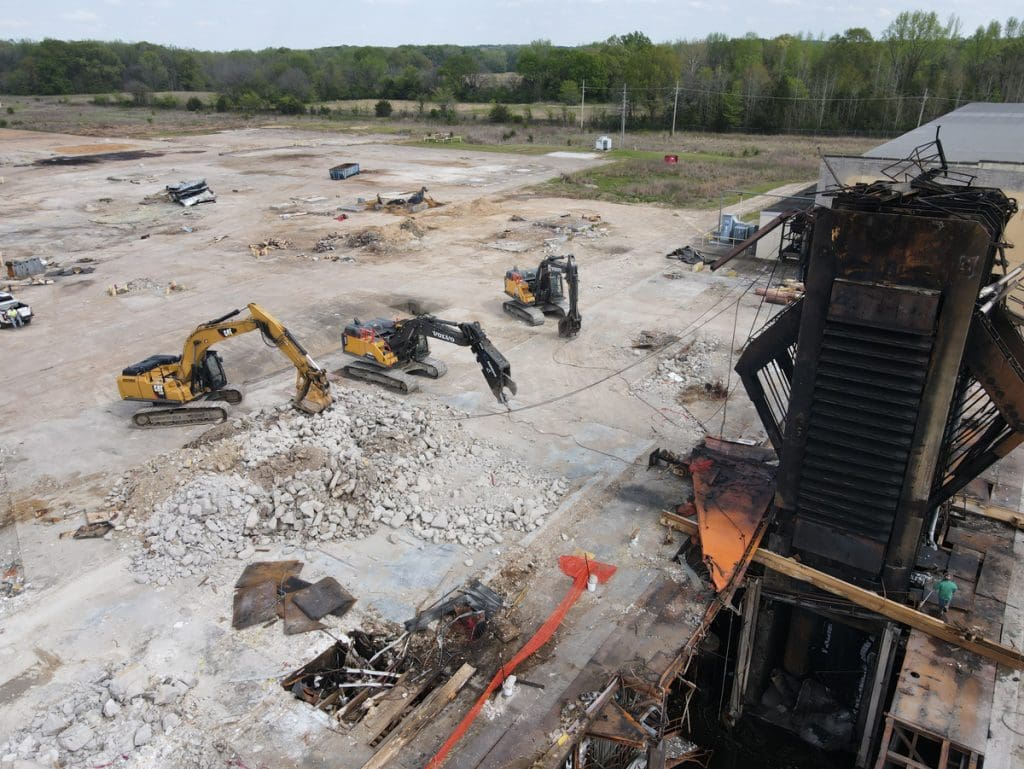 Excavators sorting debris at a demolition site