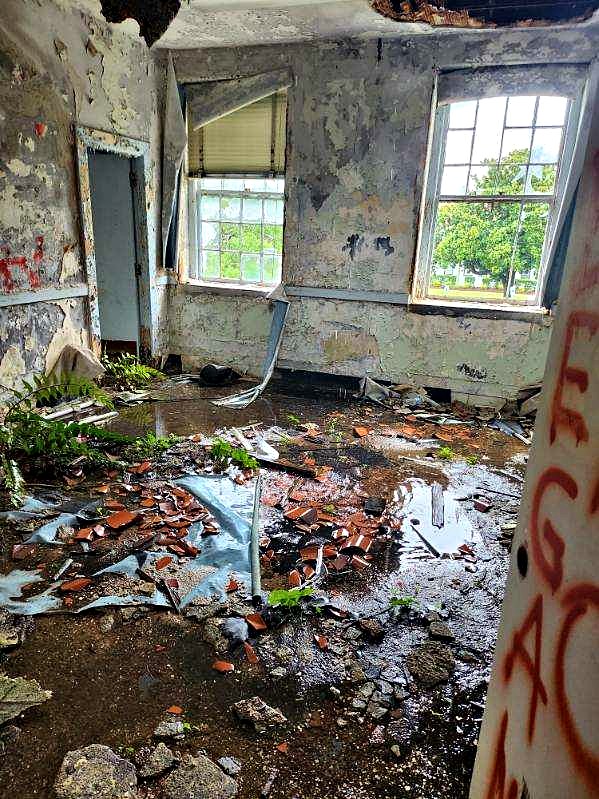 Deteriorated building interior before regulated material cleanup