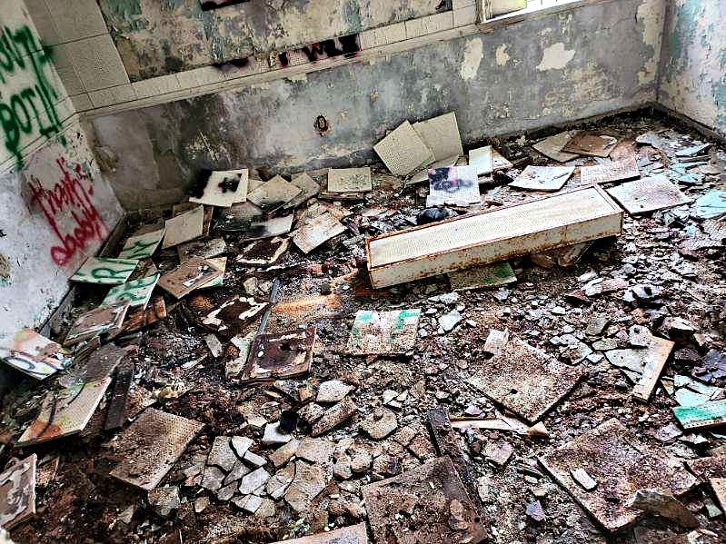 Debris-filled interior of a building before regulated material cleanup