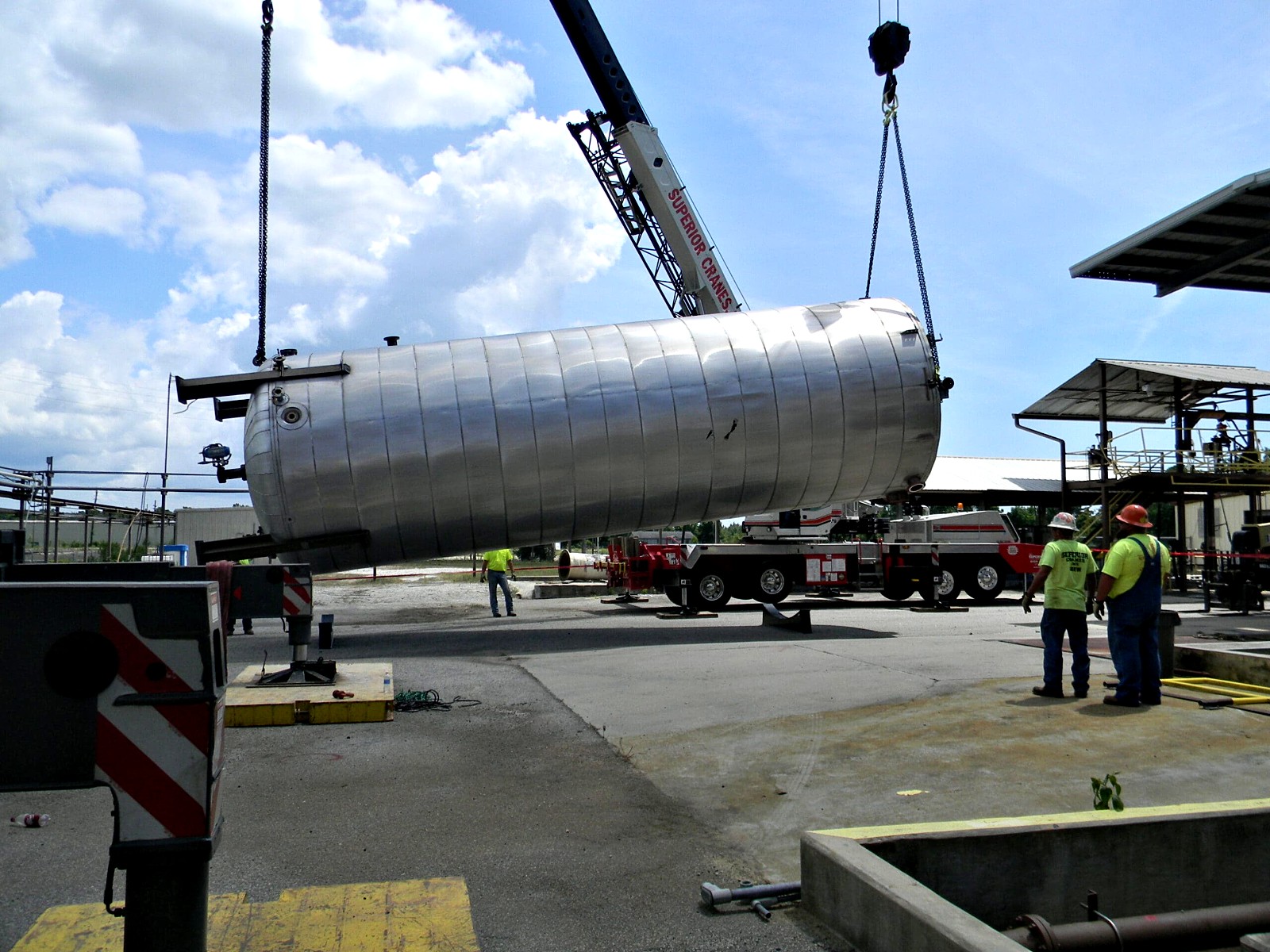 Crane lowering a tank during terminal demolition