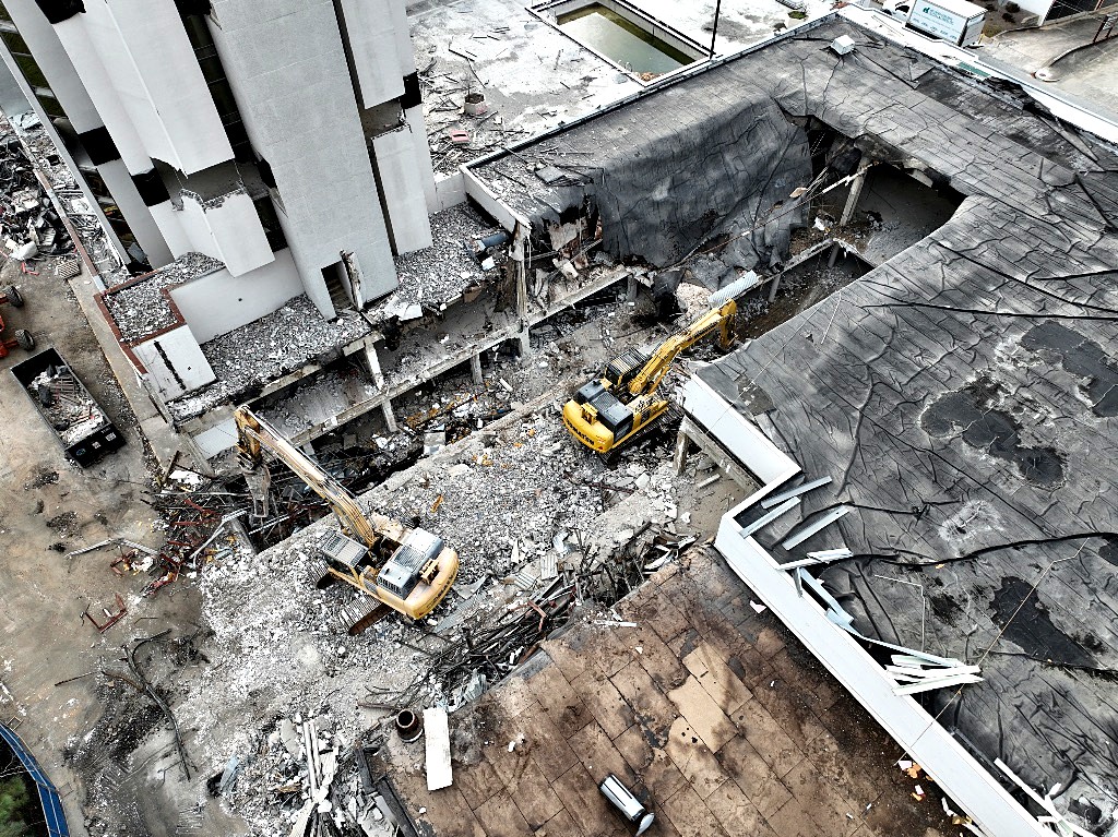 High-rise demolition with excavators working at the lower levels