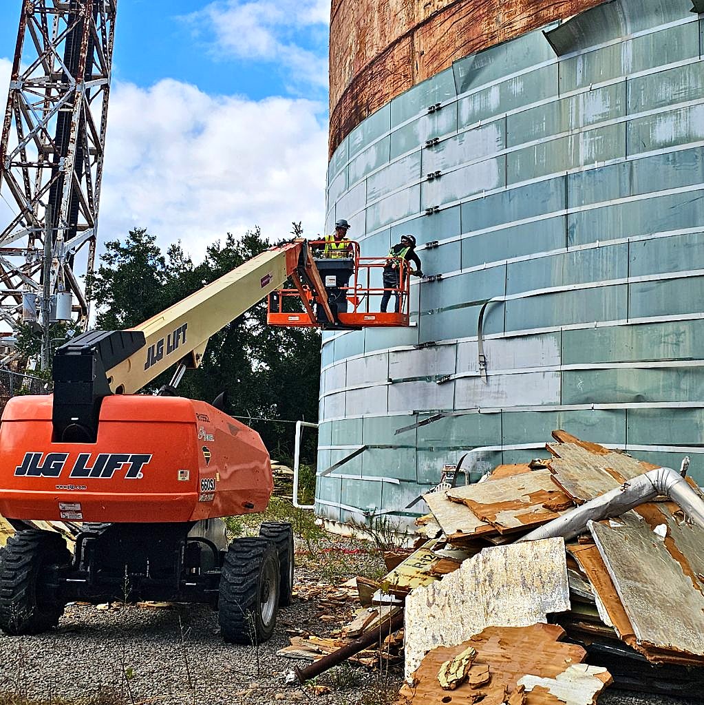 Crew working from a lift at a tank terminal