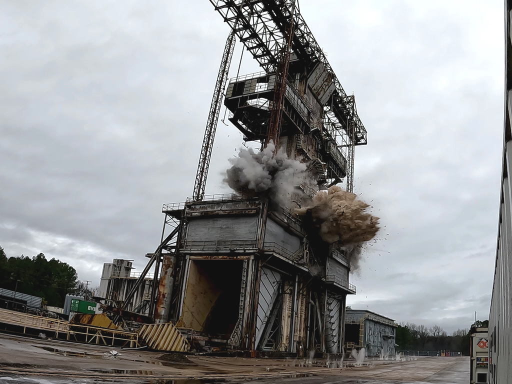 Tower implosion with a cloud of dust at its base