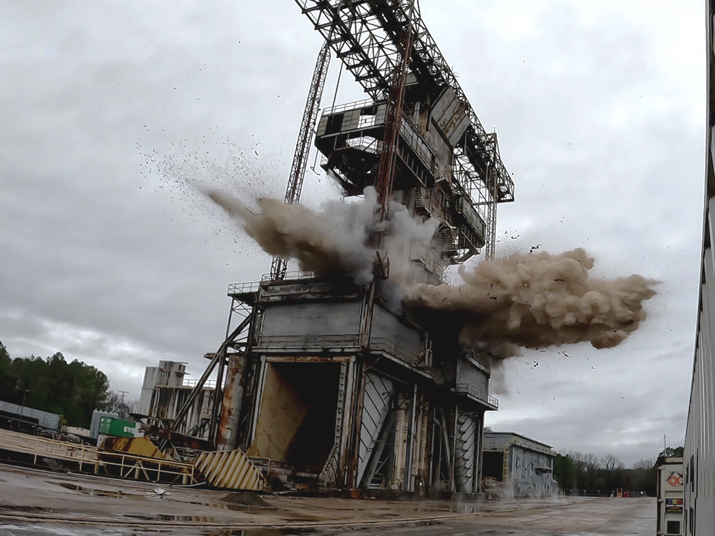 Tower implosion with a cloud of dust and debris